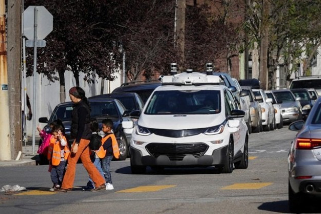 children pass by a self driving chevy bolt ev car during a media event by cruise gm s autonomous car unit in san francisco california us on november 28 2017 photo reuters children pass by a self driving chevy bolt ev car during a media event by cruise gm s autonomous car unit in san francisco california us on november 28 2017 photo reuters