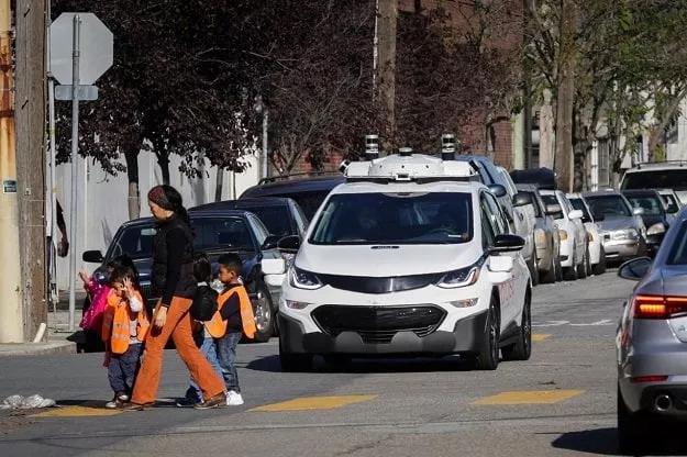 children pass by a self driving chevy bolt ev car during a media event by cruise gm s autonomous car unit in san francisco california us on november 28 2017 photo reuters children pass by a self driving chevy bolt ev car during a media event by cruise gm s autonomous car unit in san francisco california us on november 28 2017 photo reuters