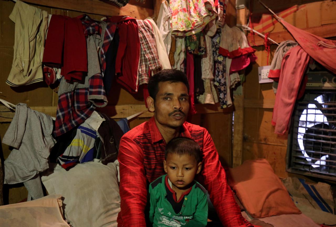 sahidullah a man from the rohingya community holds his son on his lap as he speaks with reuters inside his shack at a camp on the outskirts of jammu photo reuters