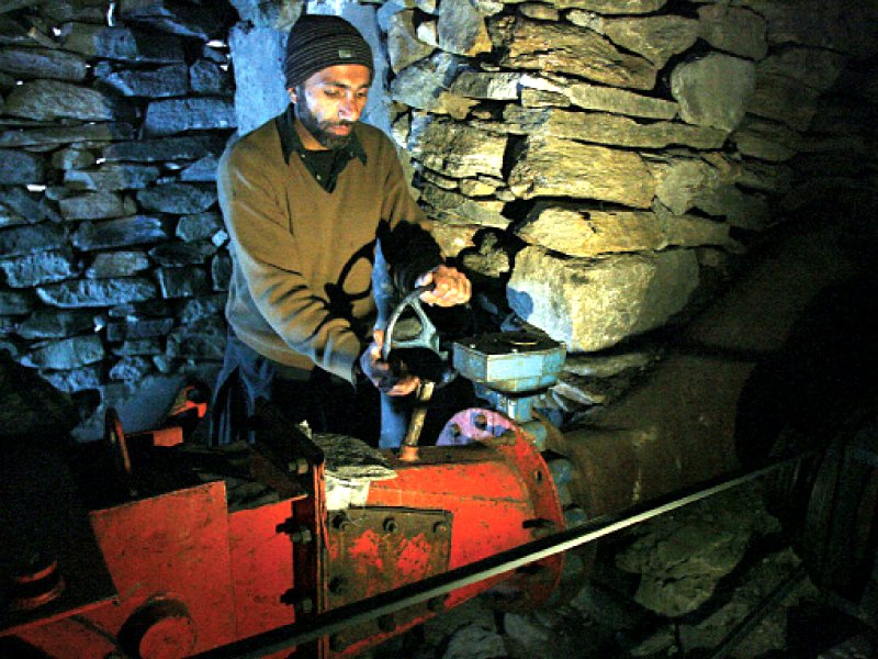 technician rahimullah operates a turbine at a small scale hydro project in neelum valley photo afp