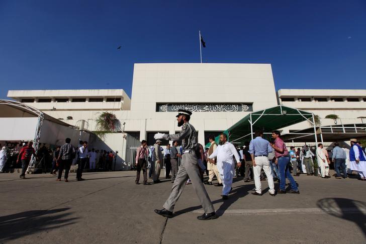 a traffic policeman walks in front of the parliament building photo reuters