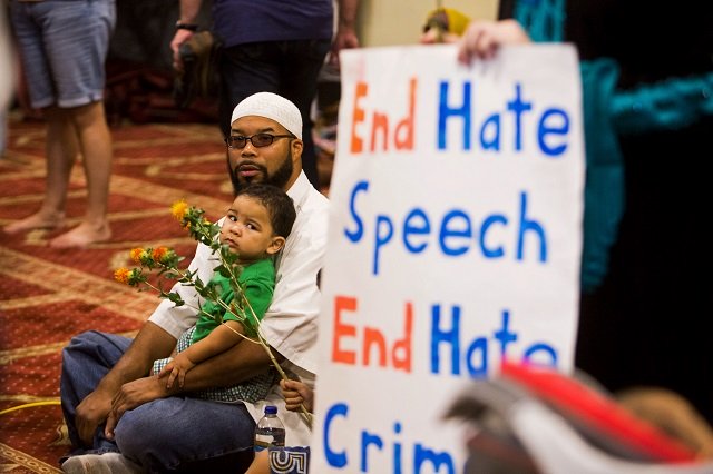 attendees sit next to a poster as speakers from different faiths speak at an interfaith rally titled quot love is stronger than hate quot at the islamic community center in phoenix arizona united states june 1 2015 the rally was held in response to an earlier anti muslim rally at the same location photo reuters