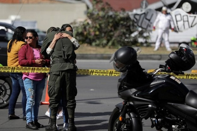 a woman embraces a police officer close to the scene where a car bomb exploded according to authorities in bogota colombia january 17 2019 photo reuters a woman embraces a police officer close to the scene where a car bomb exploded according to authorities in bogota colombia january 17 2019 photo reuters