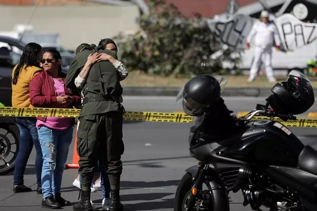 a woman embraces a police officer close to the scene where a car bomb exploded according to authorities in bogota colombia january 17 2019 photo reuters a woman embraces a police officer close to the scene where a car bomb exploded according to authorities in bogota colombia january 17 2019 photo reuters