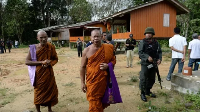 buddhist monks and armed thai police at the compound of the rattanaupap temple which was attacked by gunmen photo afp buddhist monks and armed thai police at the compound of the rattanaupap temple which was attacked by gunmen photo afp