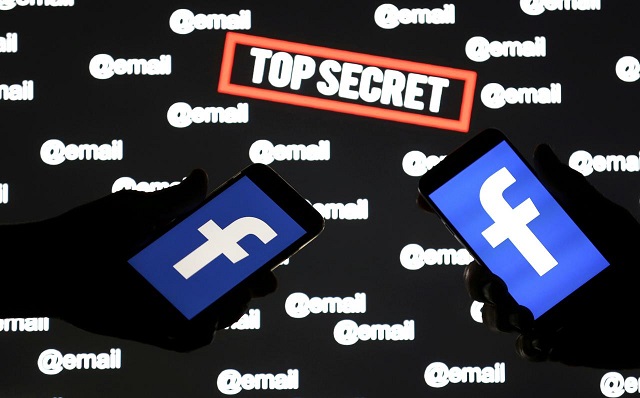 persons hold smartphones with the facebook logo in front of displayed quot top secret quot and quot email quot words in this picture illustration taken december 6 2018 photo reuters