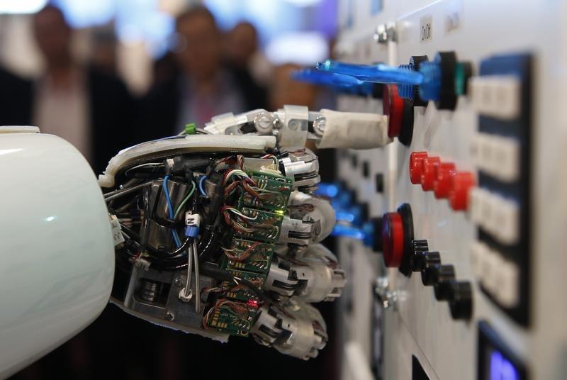 the hand of humanoid robot operates a switchboard during a demonstration photo reurers