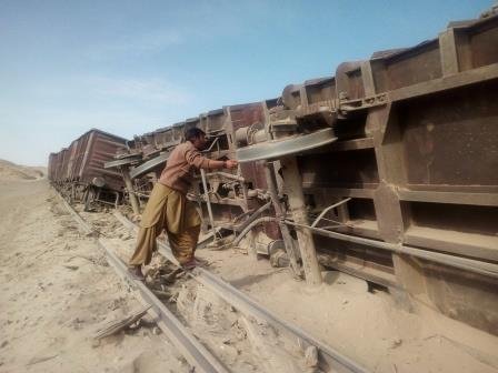 a man looks at the derailed cargo train in kaishangi area of nushki district photo express