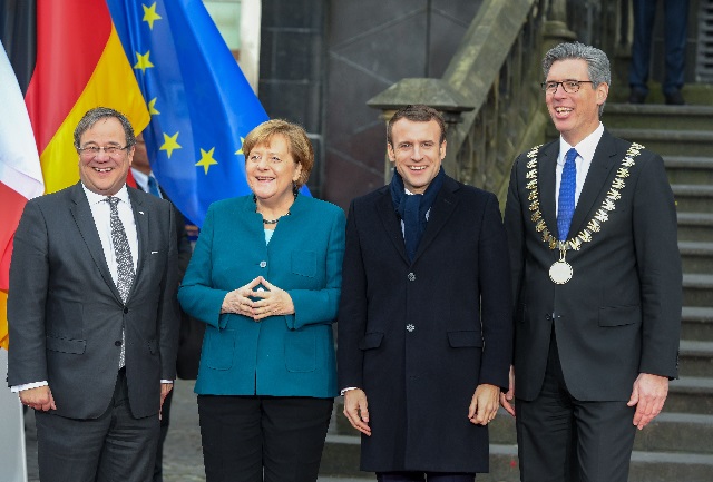 l r state premier of north rhine westphalia armin laschet german chancellor angela merkel french president emmanuel macron and aachen 039 s mayor marcel philipp pose as they arrive for the signature ceremony of a french german friendship treaty on january 22 2019 in the town hall of aachen western germany photo afp