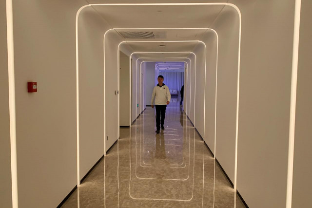 a staff member walks in the hallway during a demonstration to the media at alibaba group 039 s futuristic flyzoo hotel in hangzhou zhejiang province china photo reuters a staff member walks in the hallway during a demonstration to the media at alibaba group 039 s futuristic flyzoo hotel in hangzhou zhejiang province china photo reuters