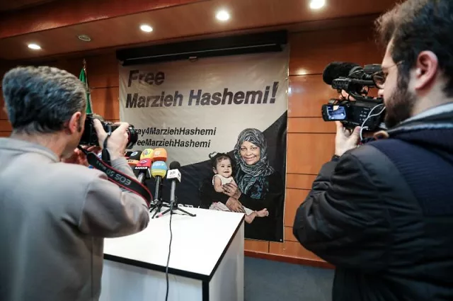 journalists in tehran photograph and film a poster calling for the release of marzieh hashemi a us born presenter for iran 039 s press tv who was arrested on a visit to her birth country photo afp