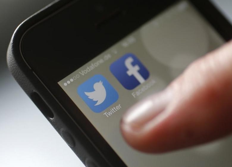 an illustration picture shows a man starting his twitter app on a mobile device photo reuters