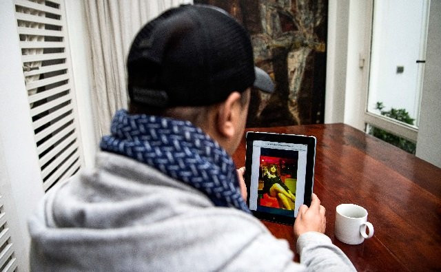 chafik lafrid a 33 year old moroccan looks at a picture of himself wearing a dress and a wig on an ipad tablet device in the capital rabat photo afp