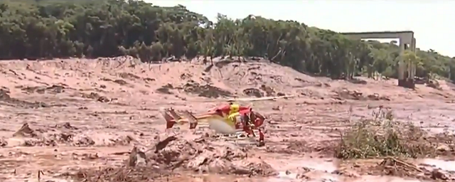 a rescue helicopter was seen hovering close to two survivors trapped up to their waist in mud photo i e n