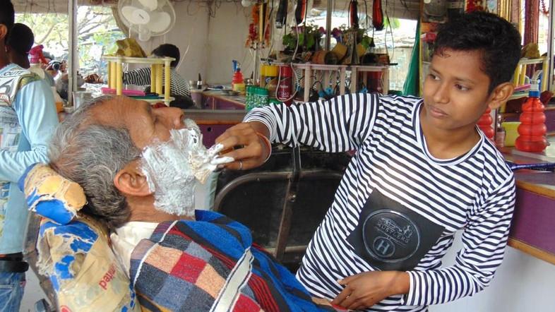 Teenage sisters in India dress as boys to run paralysed father's hair salon