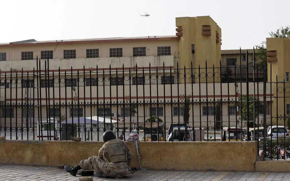 a paramilitary soldier takes up position outside the bolan medical complex as a helicopter circles above photo afp a paramilitary soldier takes up position outside the bolan medical complex as a helicopter circles above photo afp