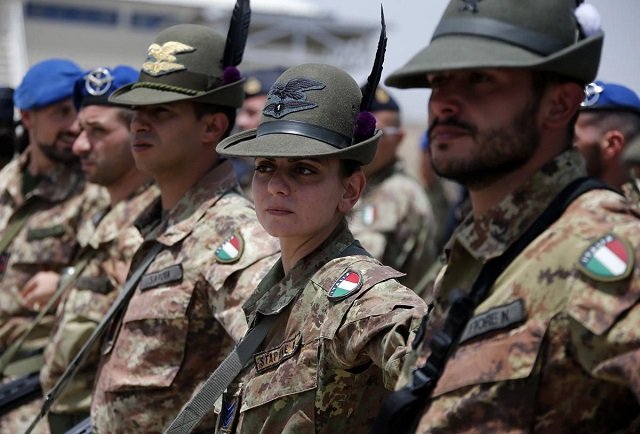 italian armed force soldiers of the mountain unit alpini stand in line at the herat airfield photo reuters