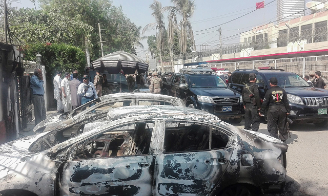 security personnel stand next to charred vehicles in front of the chinese consulate after the november 2018 attack photo afp