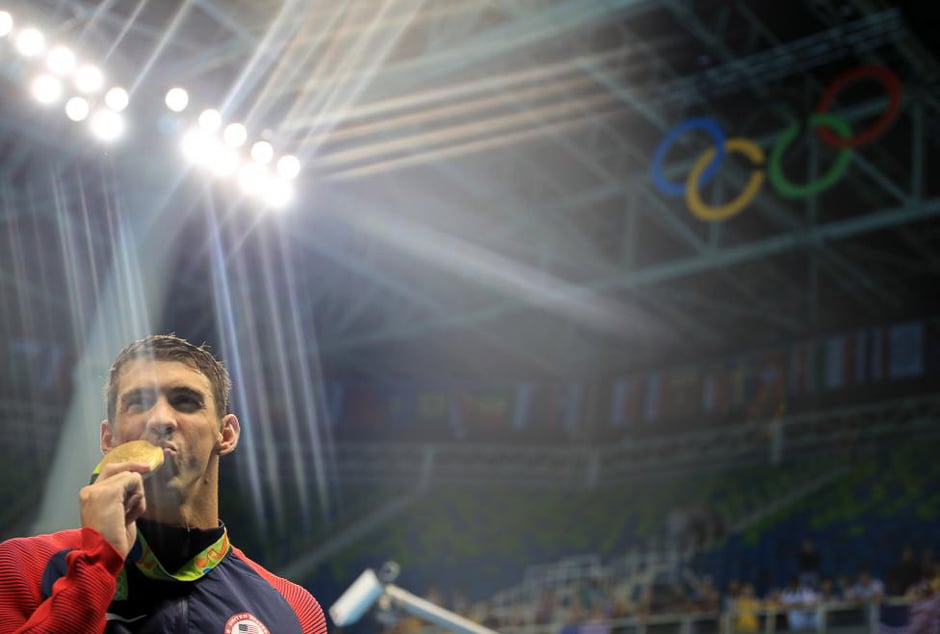 Michael Phelps of the US poses with his gold medal after the men's 4 x 200m freestyle relay at the Rio Olympics August 9, 2016. PHOTO: REUTERS