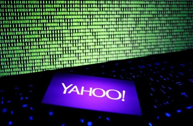a photo illustration shows a yahoo logo on a smartphone in front of a displayed cyber code and keyboard on december 15 2016 photo reuters