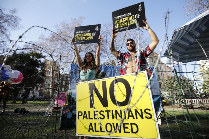 rights group amnesty international stages a demonstration outside the uk headquarters of us travel company tripadvisor in london photo afp