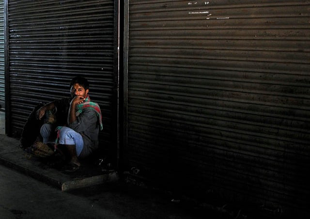file photo a daily wage worker waits for employment in front of closed shops at a market in the southern indian city of bengaluru previously known as bangalore january 12 2015 photo reuters file photo a daily wage worker waits for employment in front of closed shops at a market in the southern indian city of bengaluru previously known as bangalore january 12 2015 photo reuters