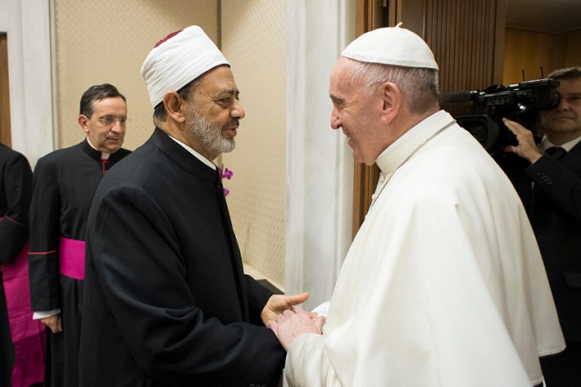 this handout photo taken and released by the vatican press office osservatore romano on november 7 2017 shows pope francis r receiving ahmed muhammad ahmed el tayeb the grand imam of al azhar during a private audience in vatican photo afp