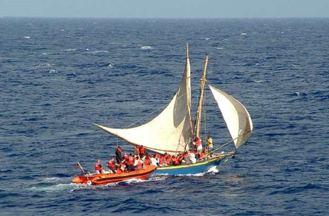 this image released 27 february 2004 by the us coast guard shows an overloaded haitian migrant vessel r being located by the us coast guard l in the windward pass between haiti and eastern cuba photo afp this image released 27 february 2004 by the us coast guard shows an overloaded haitian migrant vessel r being located by the us coast guard l in the windward pass between haiti and eastern cuba photo afp
