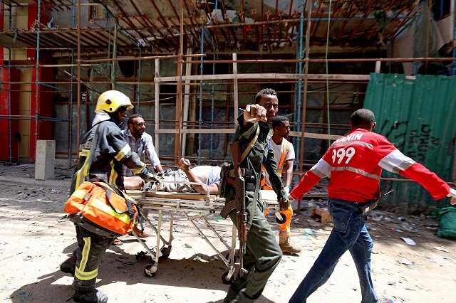 somali security forces and emergency services evacuate an injured man from the scene where a car bomb exploded at a shopping mall in mogadishu somalia february 4 2019 photo reuters feisal omar