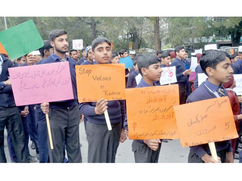 schoolchildren holding placards participate in a rally expressing solidarity with the people of occupied kashmir photo sabah