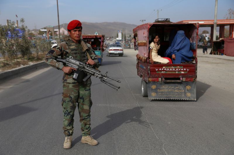 an afghan security personnel keep watch at a checkpoint in ghazni photo afp