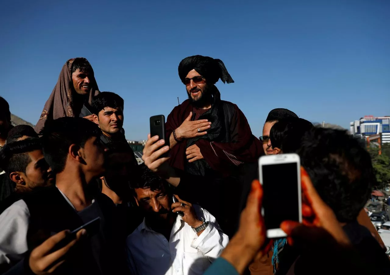 people take selfies with a taliban in kabul photo reuters people take selfies with a taliban in kabul photo reuters