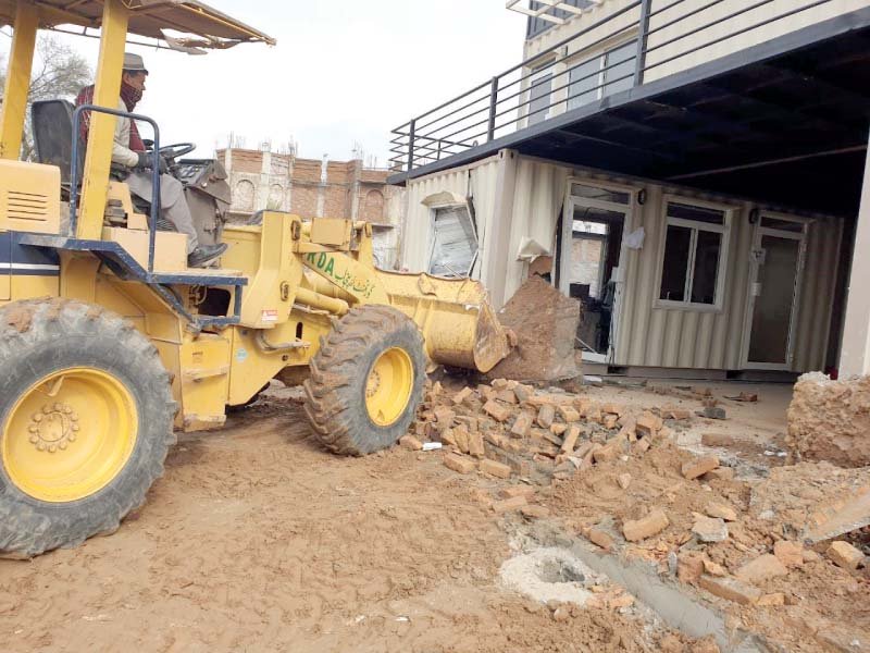 rda staff demolish offices of illegal housing societies along chakri road photo express