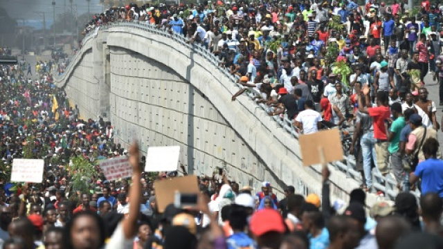 demonstrators march through the streets of port au prince on february 7 2019 photo afp