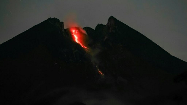 erupting indonesian volcano spews ash lava