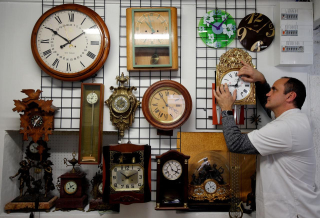 serge kertchef a watchmaker adjusts the hands on a wall clock in his workshop in marseille france photo reuters serge kertchef a watchmaker adjusts the hands on a wall clock in his workshop in marseille france photo reuters