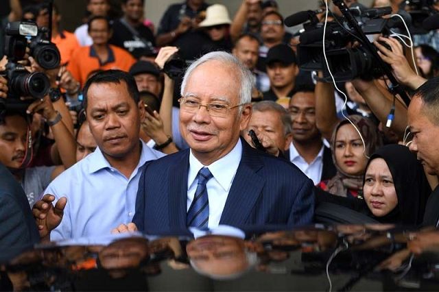 in this file photo taken on december 12 2018 former malaysia 039 s prime minister najib razak c leaves the courthouse in kuala lumpur after being charged malaysia 039 s disgraced ex leader najib razak will go on trial over an extraordinary financial scandal that contributed to the downfall of his long ruling coalition and has reverberated around the world photo afp