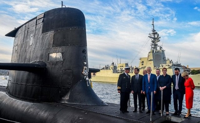 french president emmanuel macron 2nd l and australian prime minister malcolm turnbull c stand on the deck of hmas waller a collins class submarine operated by the royal australian navy at garden island in sydney on may 2 2018 photo afp