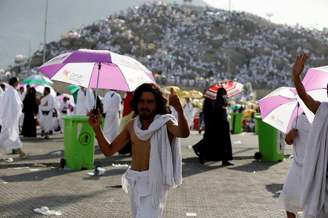 a pilgrim gestures as he gathers on the plains of arafat during hajj photo reuters