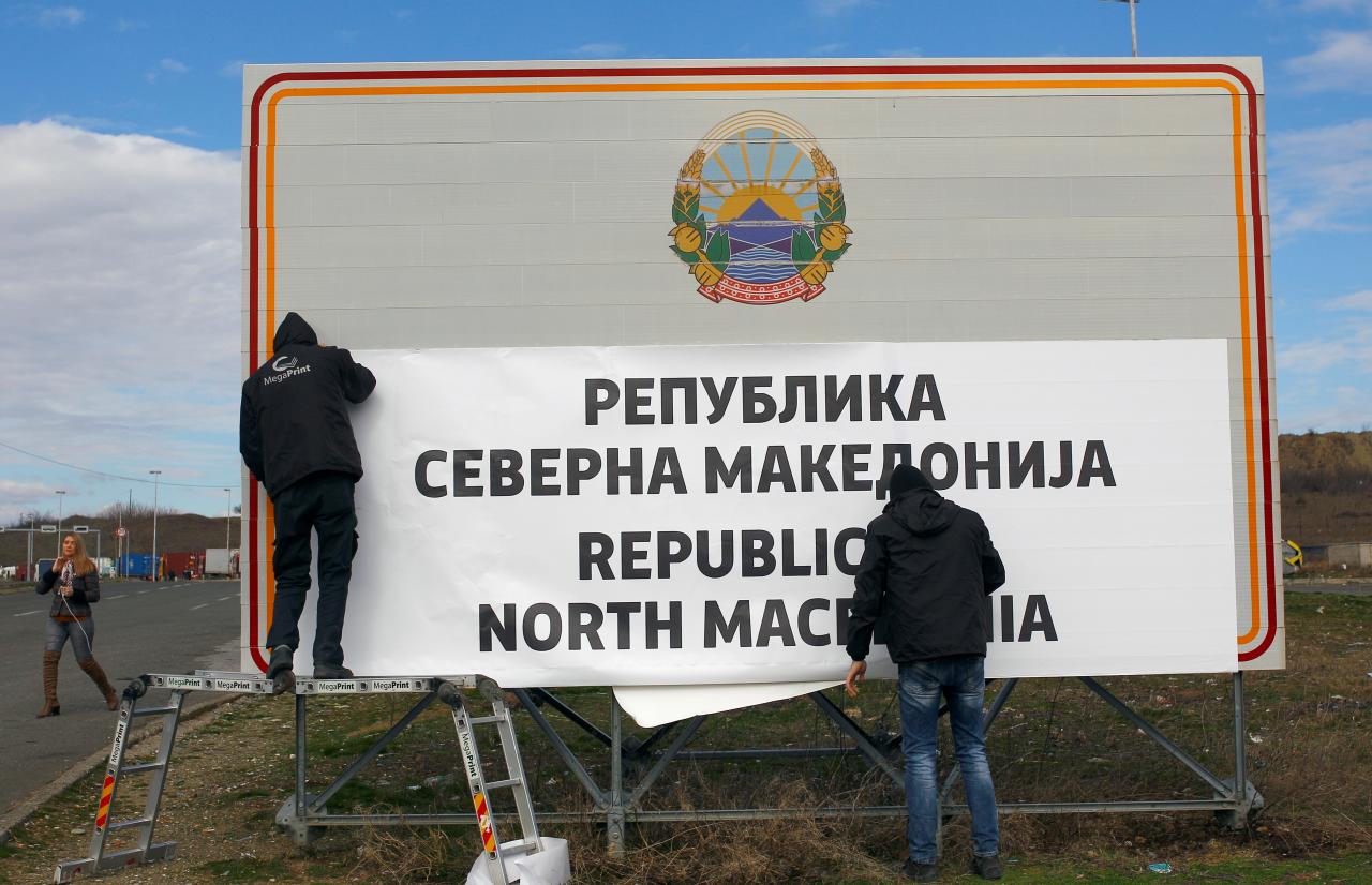 workers set up a sign with macedonia 039 s new name at the border between macedonia and greece near gevgelija macedonia photo reuters