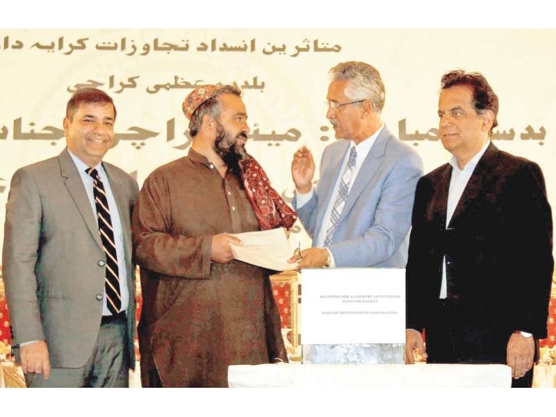 the city administration hands over allotment orders to a shopkeeper at an event on wednesday photo ppi