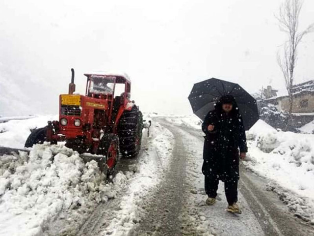 workers clear snow from road near lowari tunnel in chitral during snowfall photo express workers clear snow from road near lowari tunnel in chitral during snowfall photo express
