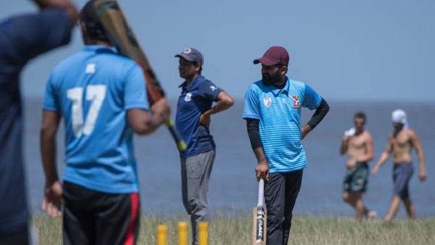indians living in uruguay play a shot during a cricket match along montevideo 039 s seaside promenade photo afp