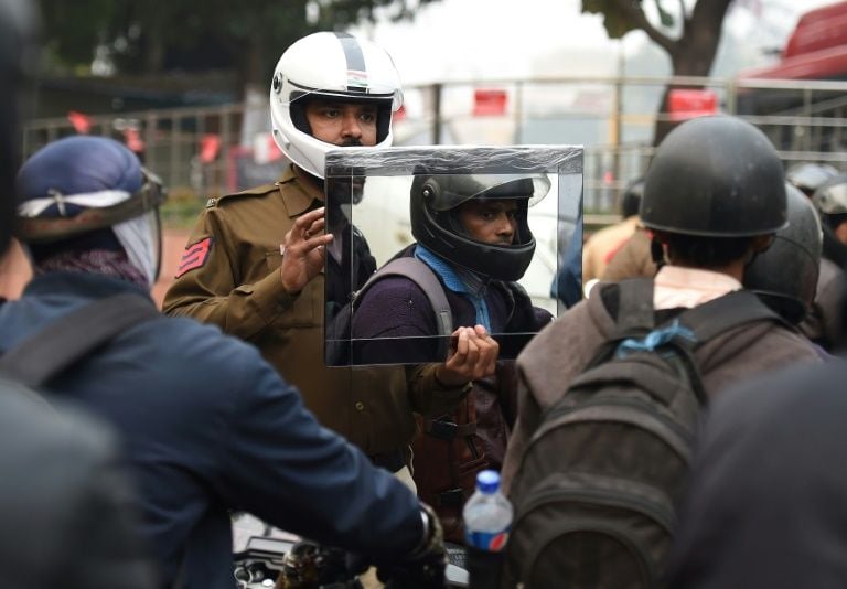 traffic cop sandeep shahi uses a mirror to shame motorbike riders into wearing a helmet photo afp