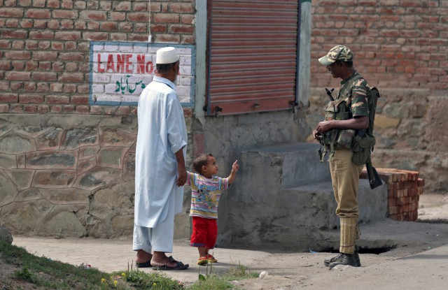 a boy gestures at a member of the occupying security forces in srinagar photo reuters a boy gestures at a member of the occupying security forces in srinagar photo reuters