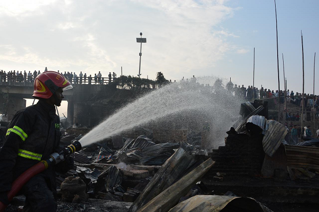 a firefighter works to extinguish fire at a slum where at least eight people killed in chittagong bangladesh february 17 2019 photo reuters