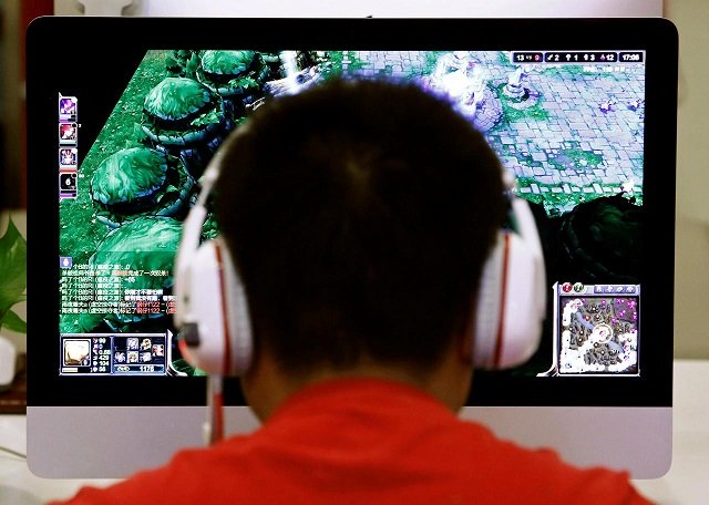 a man plays a computer game at an internet cafe in beijing china may 9 2014 photo reuters