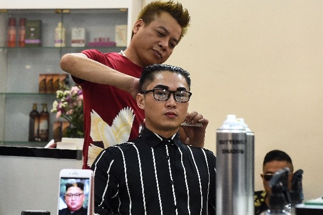 vietnamese man nguyen huu thien gets a north korean leader kim jong un style haircut at a saloon in hanoi photo afp