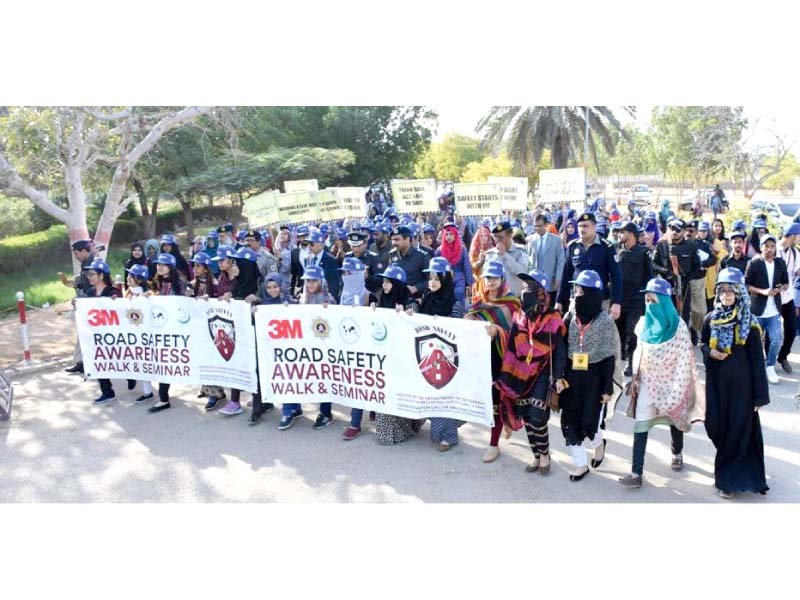 students teachers and national highway and motorway police marched from the silver jubilee gate to the arts auditorium of ku holding road safety messages photo press release