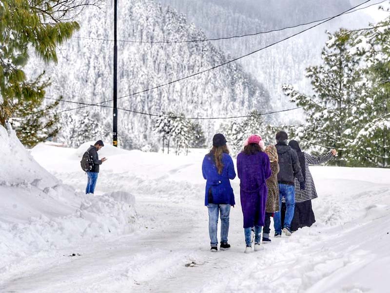 commuters stranded at lowari top while tourists enjoy a walk in snow in nathia gali photos express
